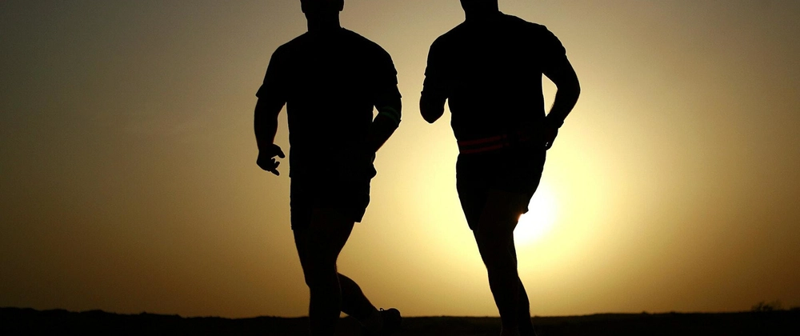 A man running a race in the early morning.
